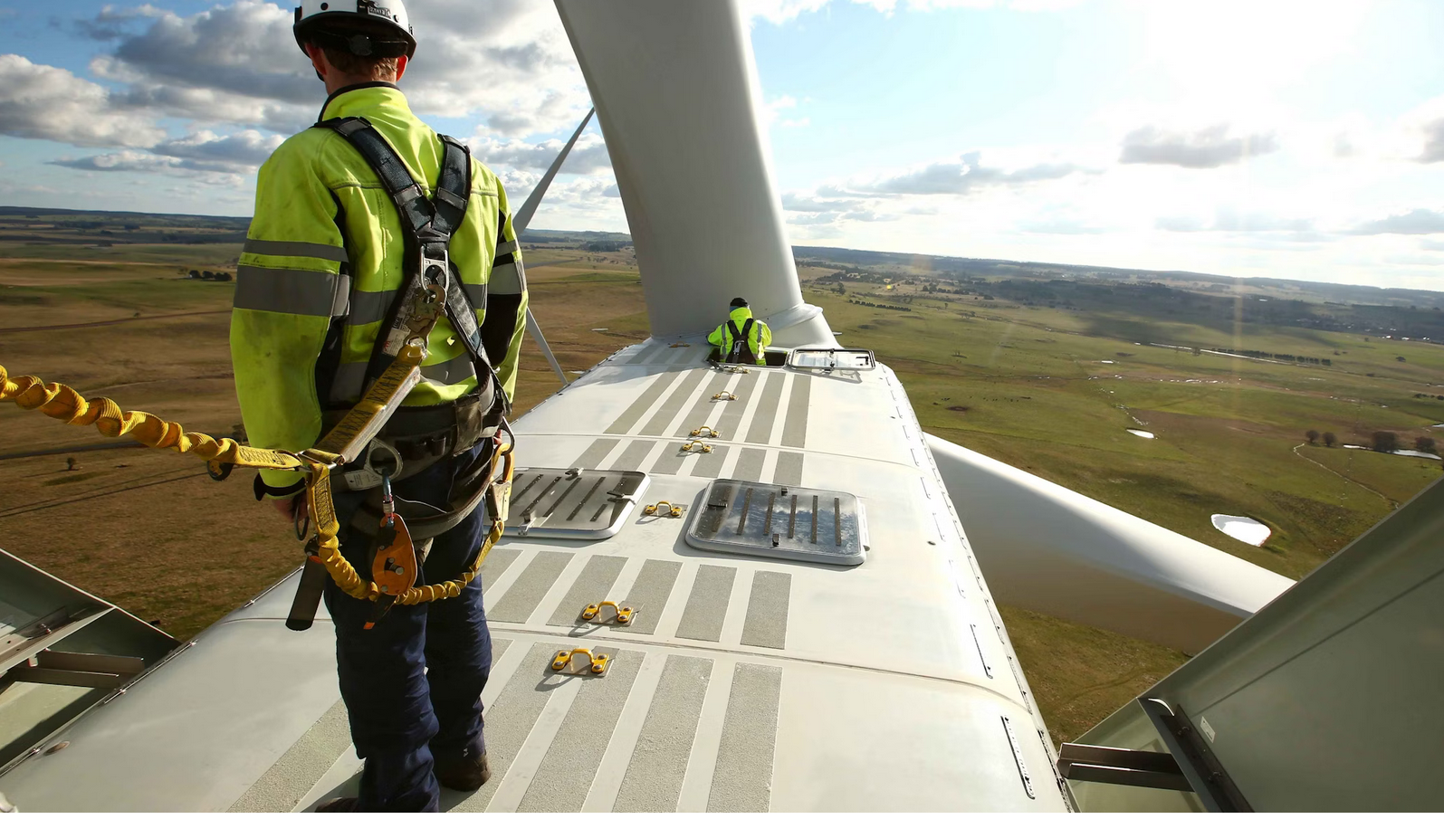 Wind technicians up a wind turbine