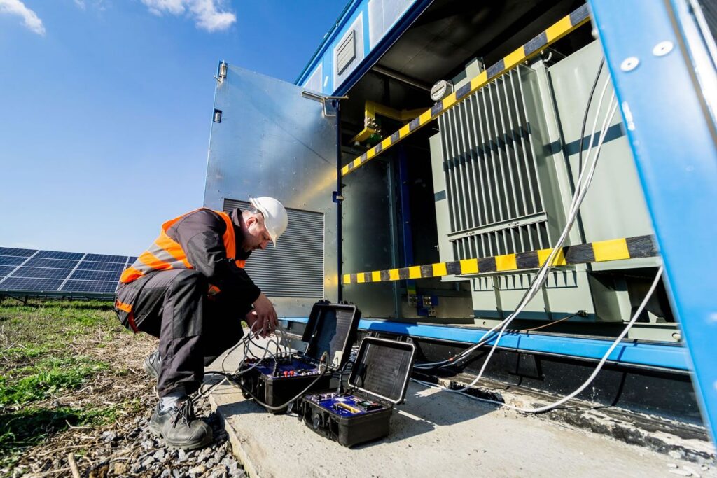 Energy field technician completing STL USA QEW electrical safety training with PPE inside a controlled substation training environment.